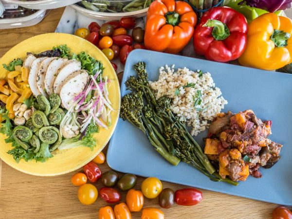 Refeição vegetariana colorida com legumes frescos e grãos dispostos em um prato